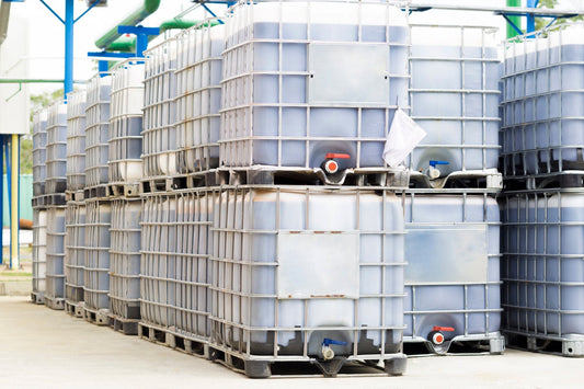 white ibc totes stacked on top of each other