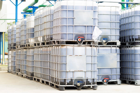 white ibc totes stacked on top of each other